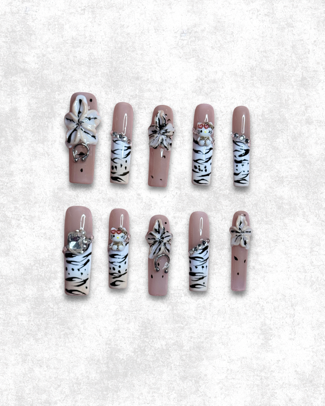front view Petal Predator press on nails with zebra print accents and 3D flower charms on a nude base